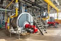 industrial boilers in a factory with red and yellow pipes